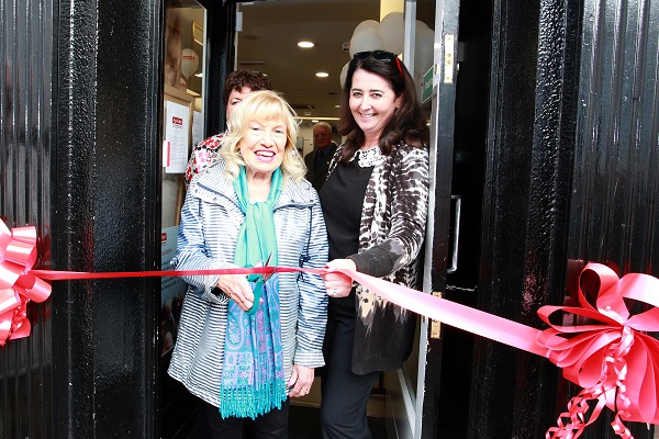 Age Action Deputy Chief Executive Lorraine Fitzsimons holds the ribbon for customer June Smyth