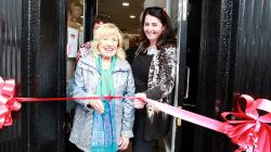 Age Action Deputy Chief Executive Lorraine Fitzsimons holds the ribbon for customer June Smyth